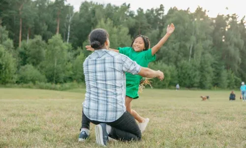 girl running towards a man for a hug