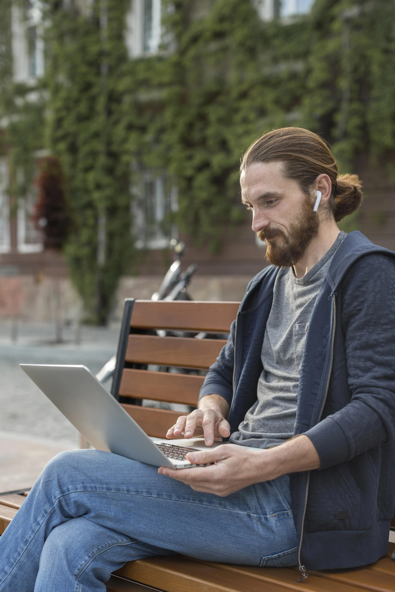 Side view man working laptop city